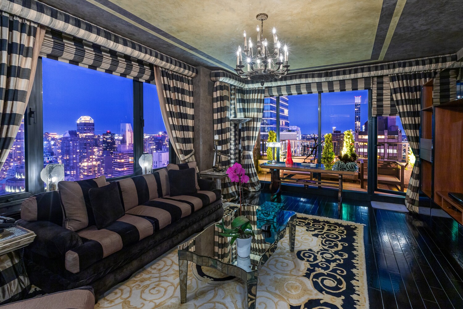 117 East 57th Street, Unit 49D/51D Manhattan, NY 10022 - Photo 16 of 46 a living room with lots of furniture and chandelier