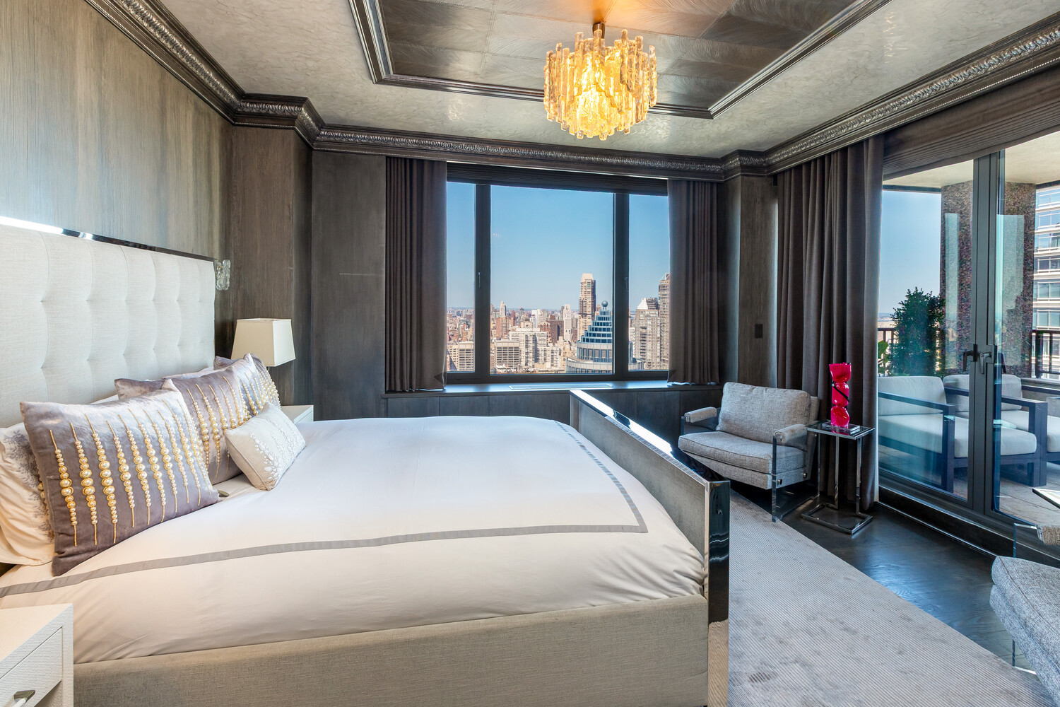 117 East 57th Street, Unit 49D/51D Manhattan, NY 10022 - Photo 28 of 46 a bedroom with furniture and a large window