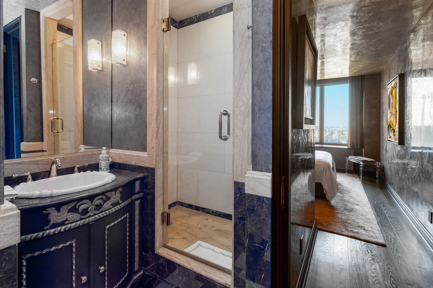 117 East 57th Street, Unit 49D/51D Manhattan, NY 10022 - Photo 32 of 46 a en suite bathroom with a sink a mirror and shower