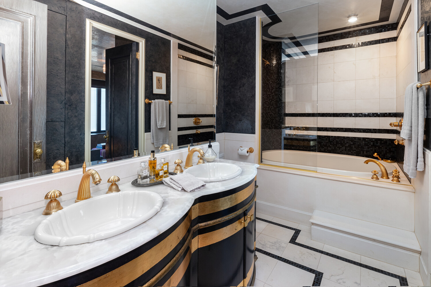 117 East 57th Street, Unit 49D/51D Manhattan, NY 10022 - Photo 33 of 46 a bathroom with a sink and a mirror