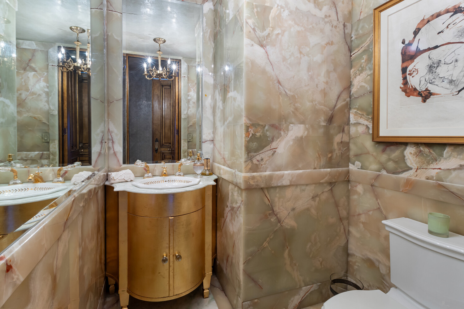 117 East 57th Street, Unit 49D/51D Manhattan, NY 10022 - Photo 34 of 46 a bathroom with a sink mirror and toilet