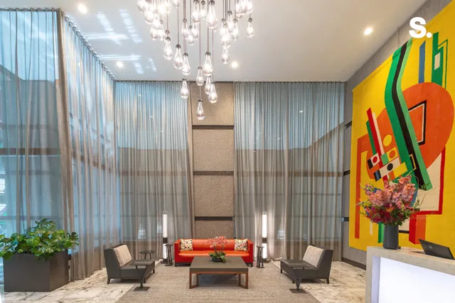 a living room with furniture and a chandelier