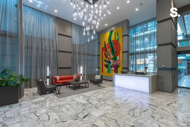 a living room filled with furniture and a chandelier