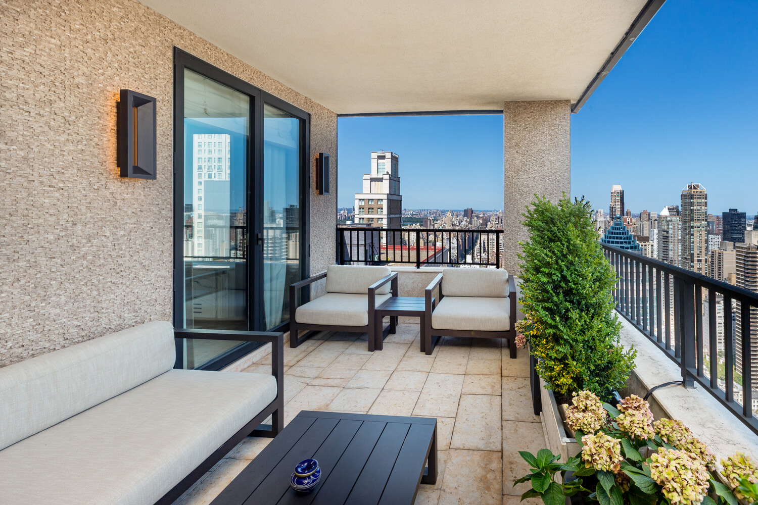 117 East 57th Street, Unit 49D/51D Manhattan, NY 10022 - Photo 6 of 46 a balcony with furniture and view of outdoor space
