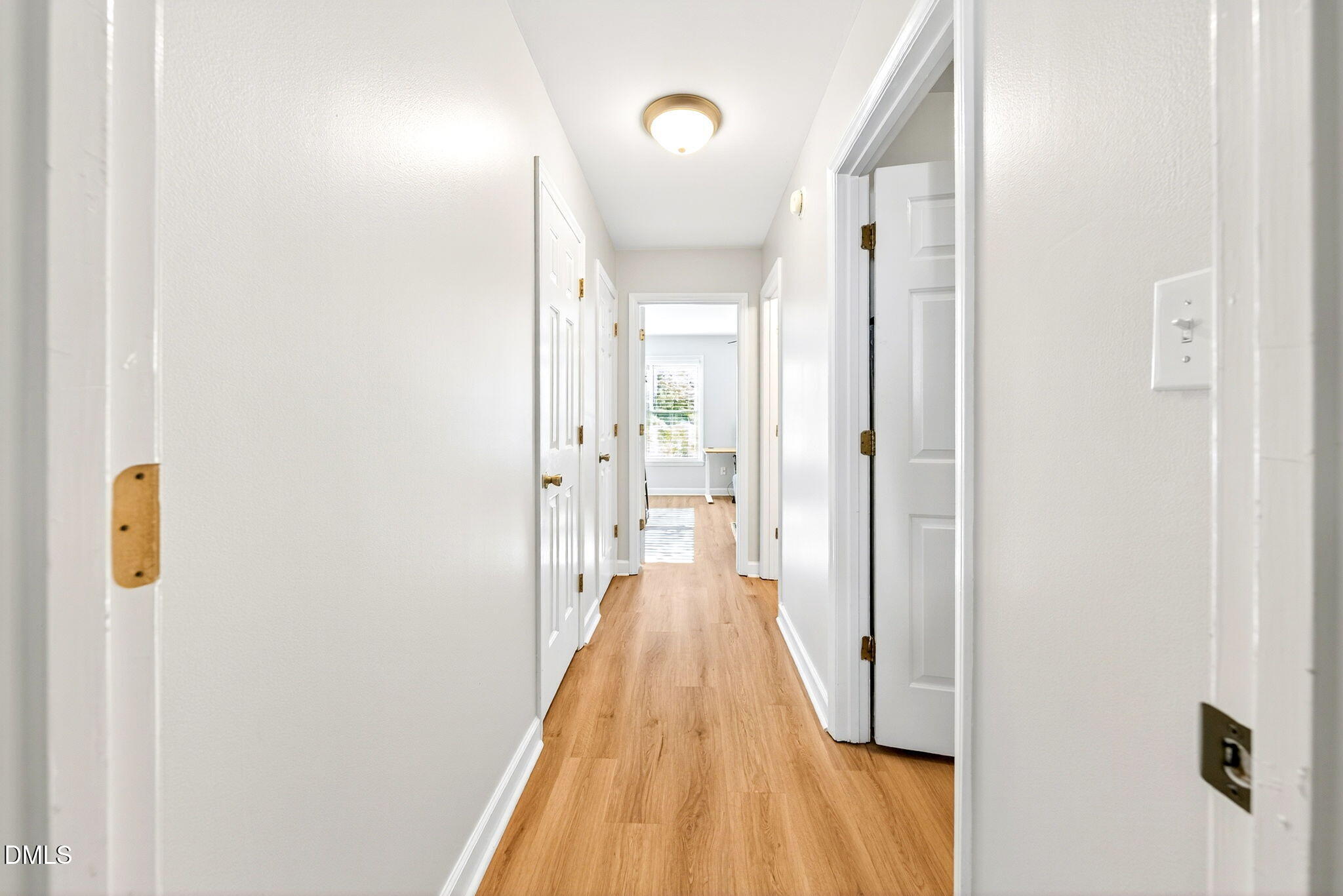 3307 Tarleton West Durham, NC 27713 - Photo 21 of 39 Looking down the hallway toward the second bedroom. The laundry room and guest bathroom are on the right, the panty and a closet with the furnace are on the left.