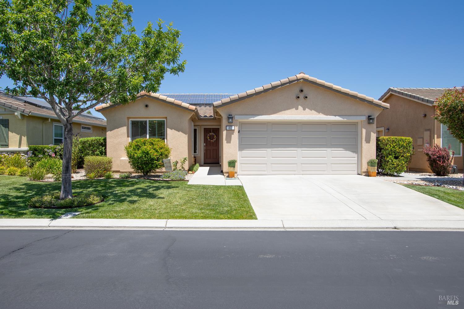 a front view of a house with a yard and garage