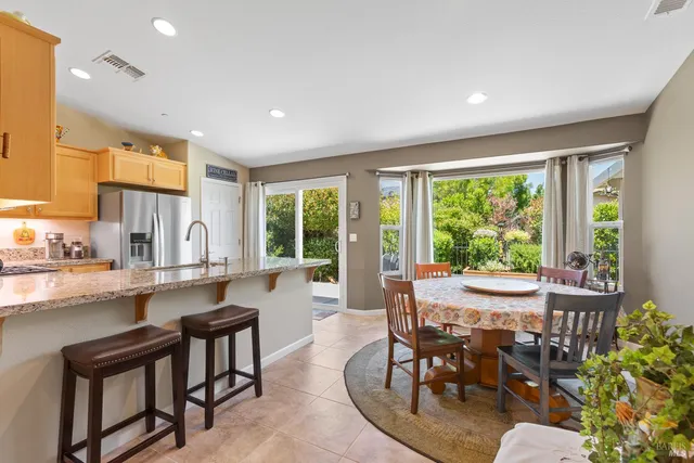 a view of a dining room with furniture window and outside view
