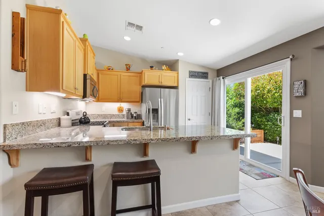 a kitchen with stainless steel appliances granite countertop a sink and cabinets