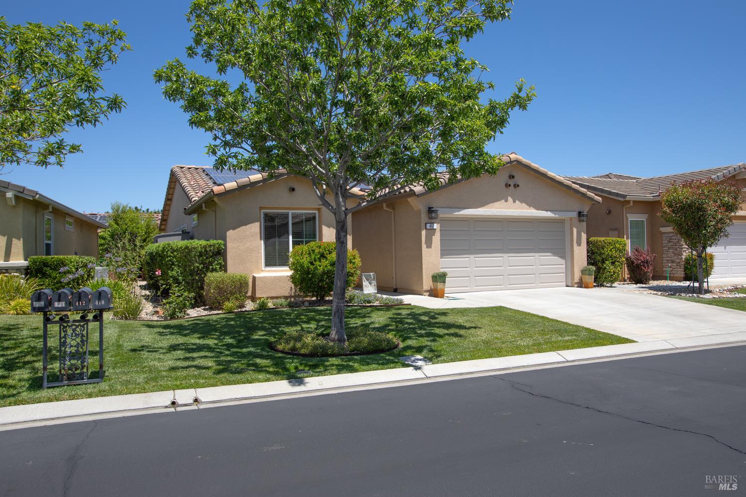 412 Spring Creek Drive Rio Vista, CA 94571 - Photo 2 of 42 a front view of a house with a yard and garage