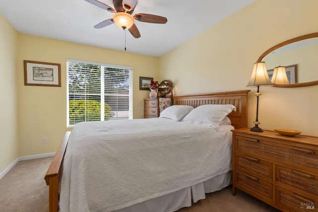 a bed sitting in a bedroom next to a window