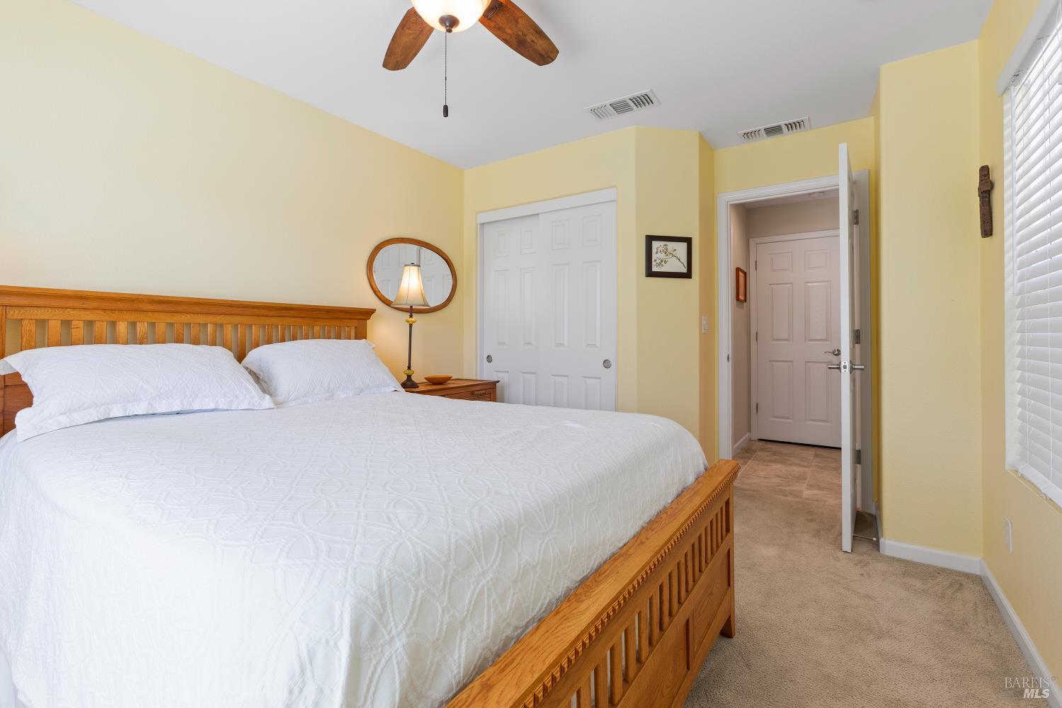 412 Spring Creek Drive Rio Vista, CA 94571 - Photo 27 of 42 a bedroom with a bed and a chandelier