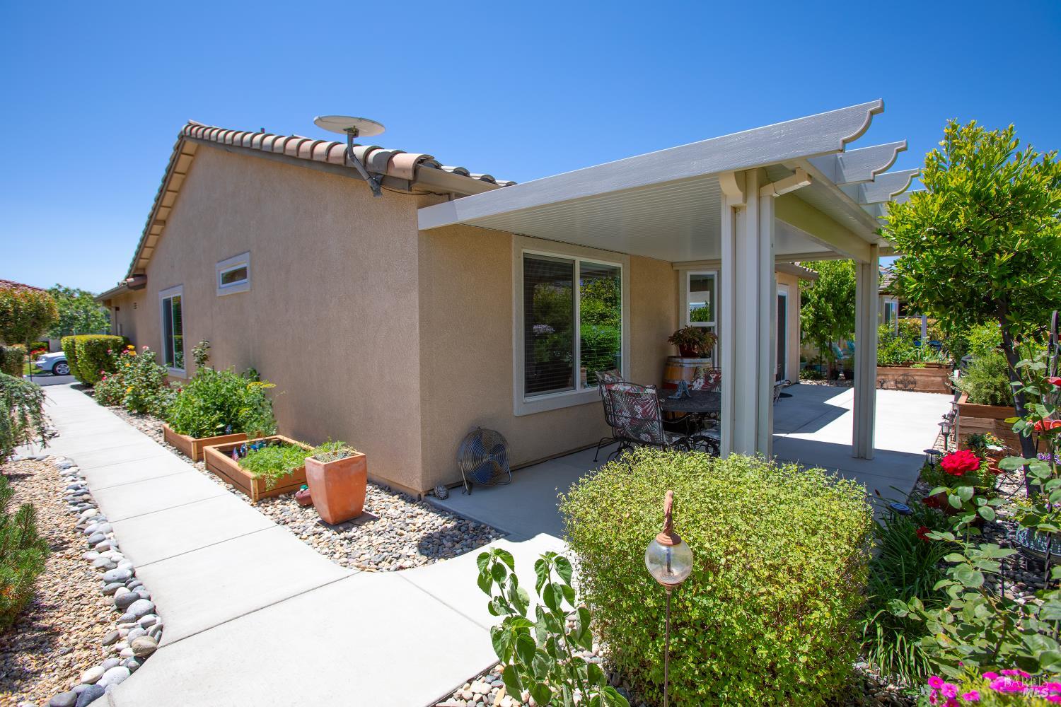 412 Spring Creek Drive Rio Vista, CA 94571 - Photo 32 of 42 a view of a house with a small yard and flower plants