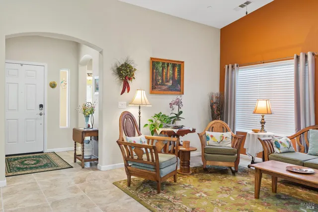 a living room with furniture and a potted plant