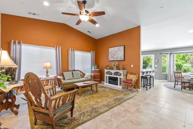 a living room with furniture a flat screen tv and a large window
