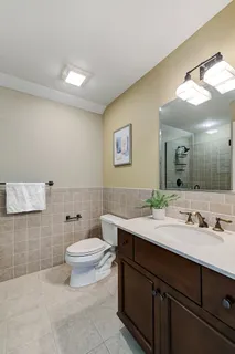 a bathroom with a sink a toilet and mirror