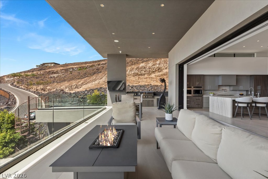 657 Ridgestone Rim Court Henderson, NV 89012 - Photo 51 of 97 Seamless indoor-outdoor living merges with sleek modern architecture looking out toward rugged hillsides.