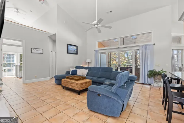 a kitchen with stainless steel appliances granite countertop table chairs sink and cabinets