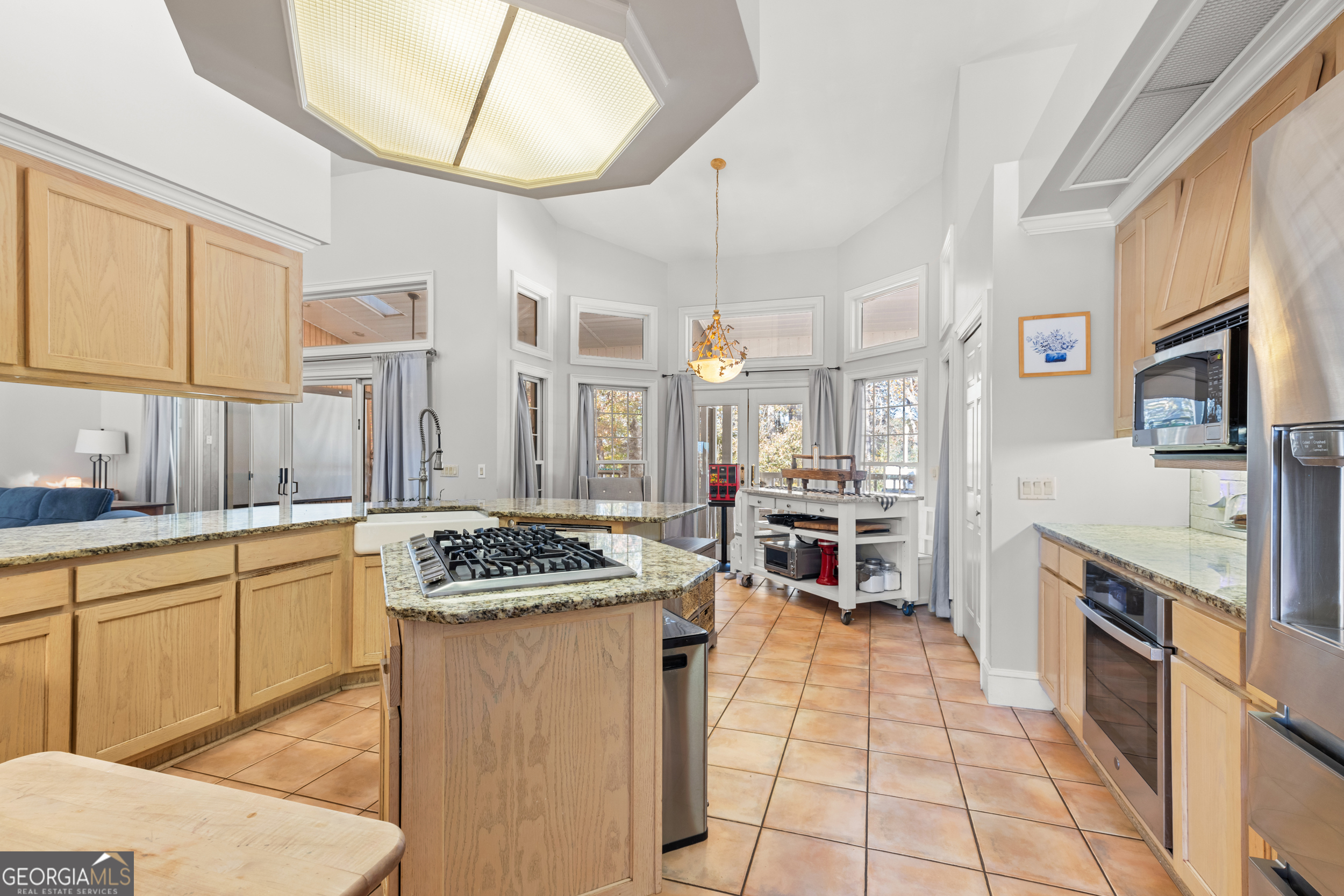 593 Cross Creek Drive Toccoa, GA 30577 - Photo 17 of 55 a kitchen with stainless steel appliances granite countertop a stove a sink and a microwave