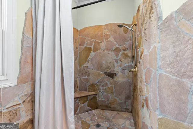 a bathroom with a granite countertop sink a toilet and a mirror