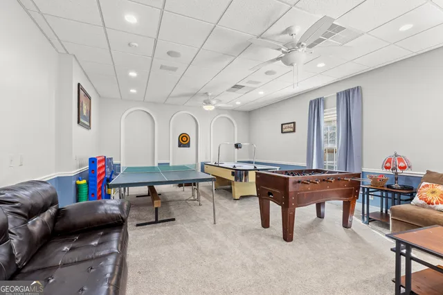 a living room with furniture and a book shelf