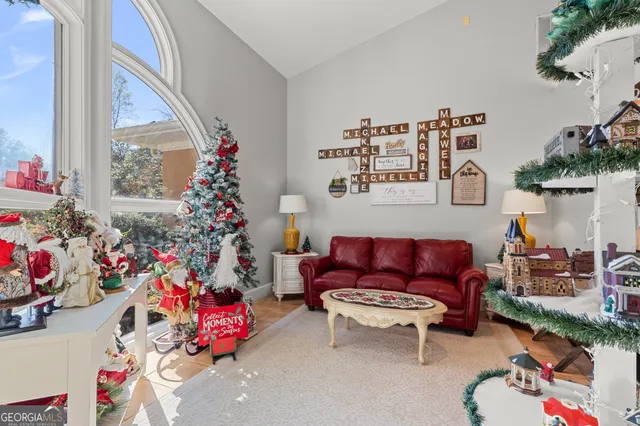 a living room with furniture and a flat screen tv
