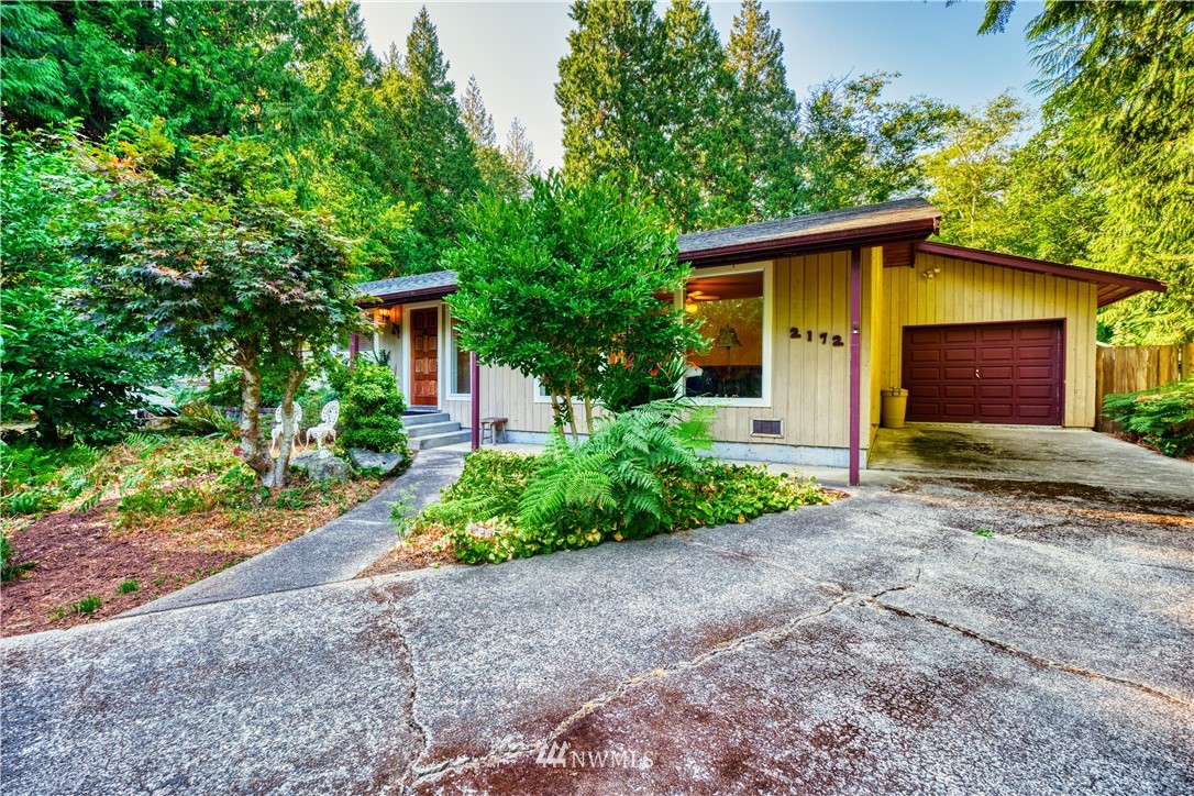 2172 Foxhole Road Point Roberts, WA 98281 - Photo 2 of 40 a front view of a house with garden
