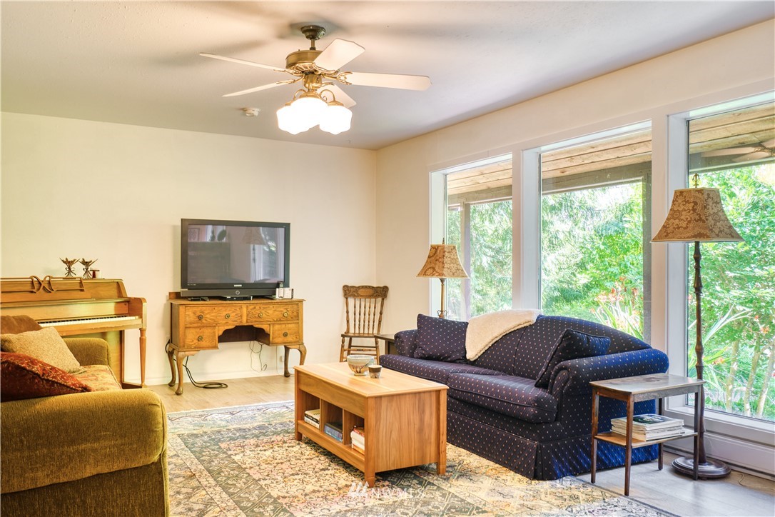 2172 Foxhole Road Point Roberts, WA 98281 - Photo 12 of 40 a living room with furniture a flat screen tv and a large window