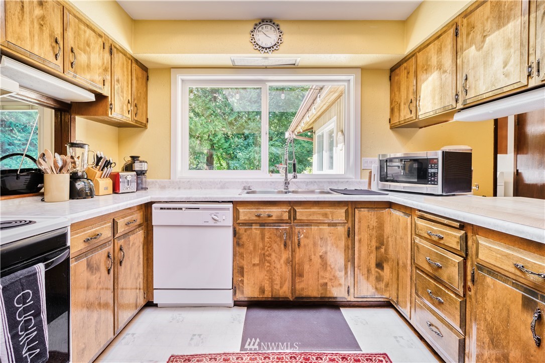 2172 Foxhole Road Point Roberts, WA 98281 - Photo 18 of 40 a kitchen with stainless steel appliances granite countertop a stove and a sink