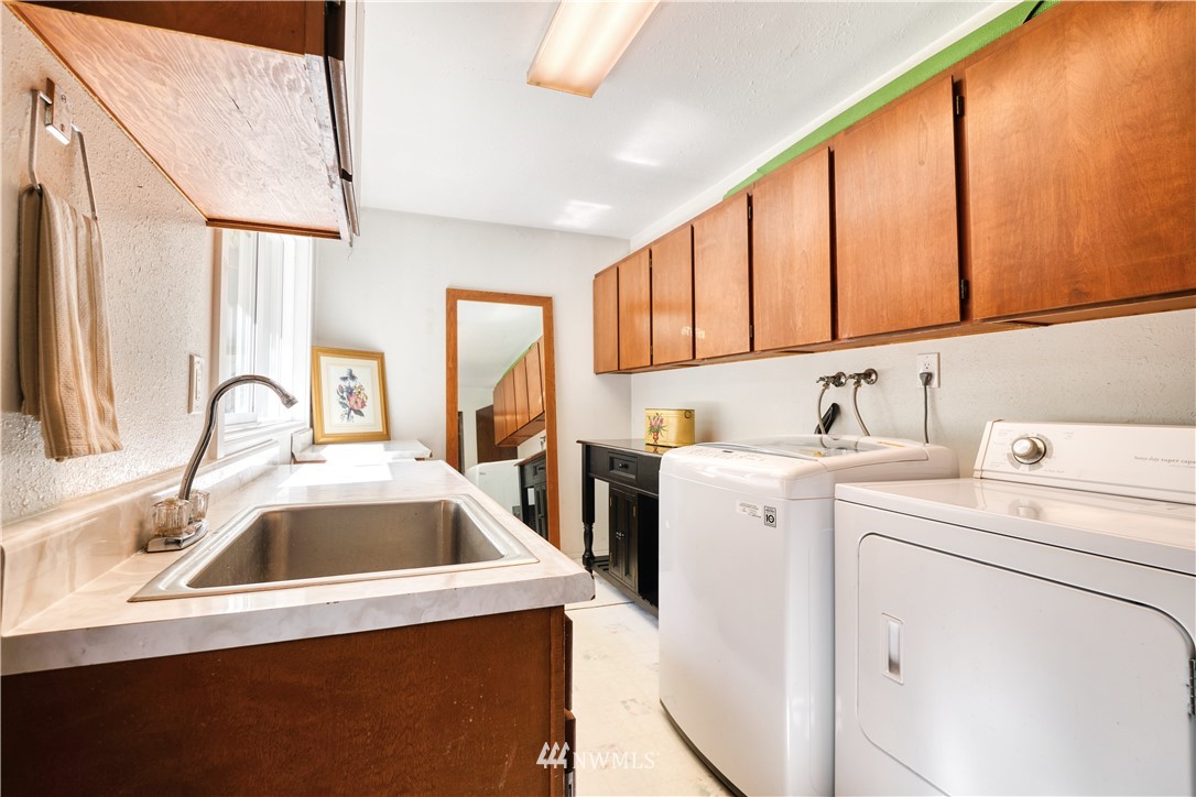 2172 Foxhole Road Point Roberts, WA 98281 - Photo 21 of 40 a view of a kitchen with sink and washer dryer