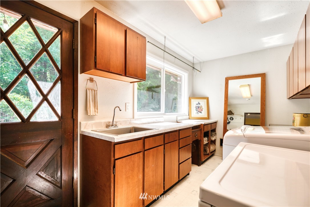 2172 Foxhole Road Point Roberts, WA 98281 - Photo 22 of 40 a kitchen with stainless steel appliances granite countertop a sink and a stove
