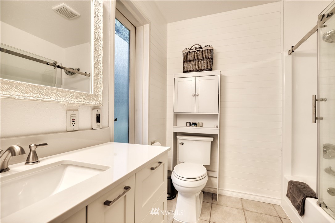 2172 Foxhole Road Point Roberts, WA 98281 - Photo 24 of 40 a bathroom with a toilet sink vanity and mirror
