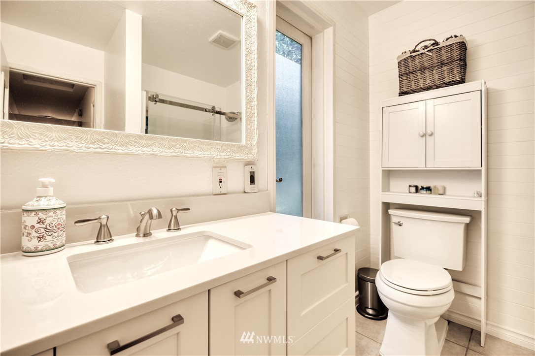 2172 Foxhole Road Point Roberts, WA 98281 - Photo 25 of 40 a bathroom with a toilet a sink and a mirror