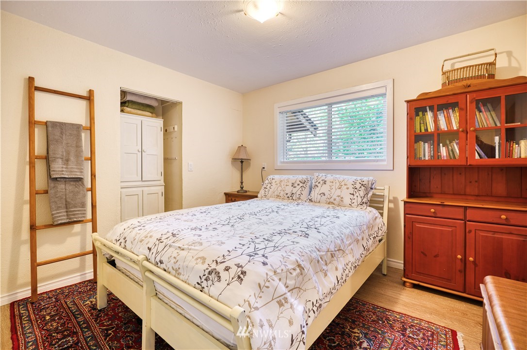 2172 Foxhole Road Point Roberts, WA 98281 - Photo 26 of 40 a bedroom with a bed and a dresser next to a window