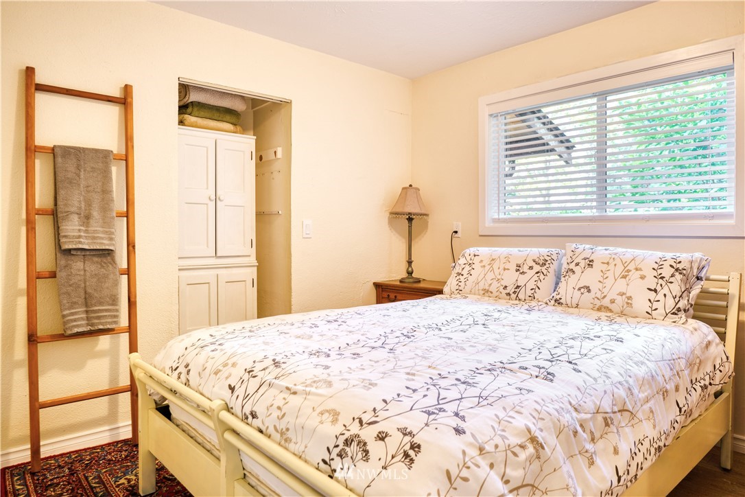 2172 Foxhole Road Point Roberts, WA 98281 - Photo 27 of 40 a bedroom with a large bed and a large window