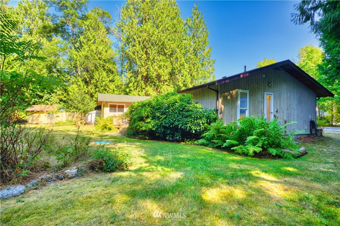 2172 Foxhole Road Point Roberts, WA 98281 - Photo 4 of 40 a view of a house with a yard and plants