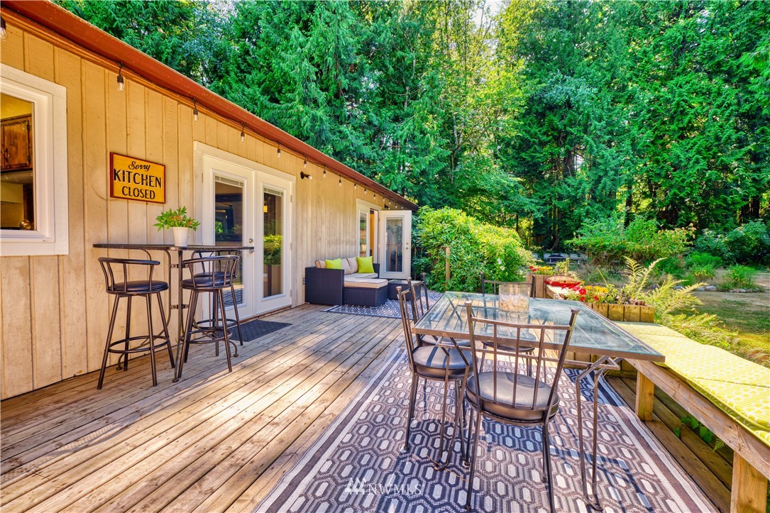 2172 Foxhole Road Point Roberts, WA 98281 - Photo 7 of 40 a patio with wooden floor and outdoor seating
