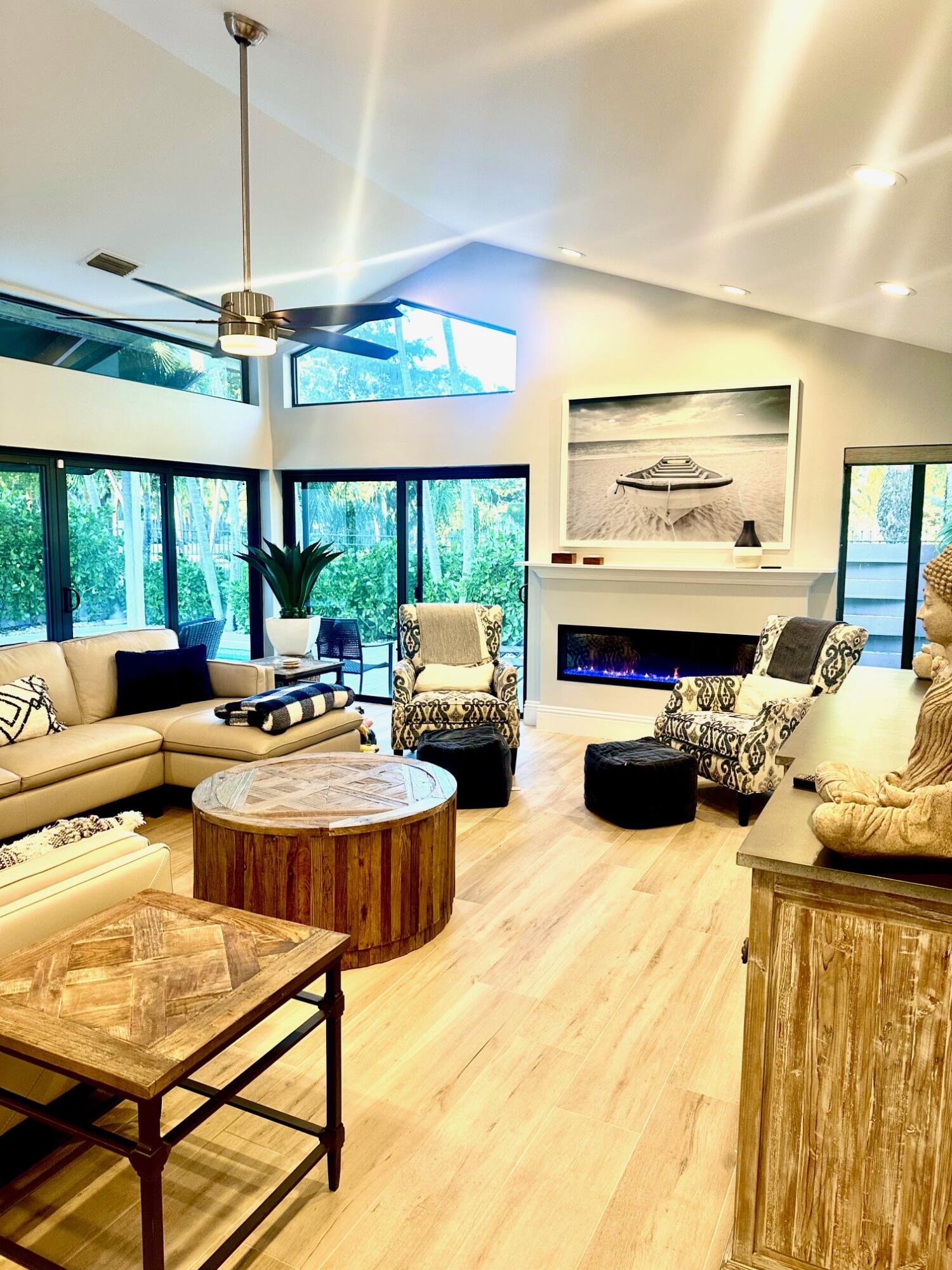 21634 Club Villa Terrace Boca Raton, FL 33433 - Photo 3 of 3 a living room with furniture a flat screen tv and a chandelier