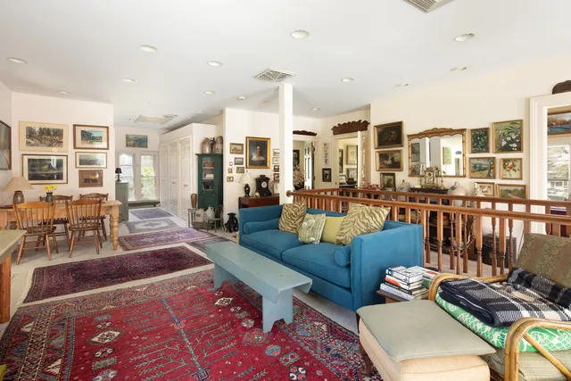 a living room with furniture and large windows