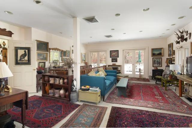 a living room with furniture and a dining table