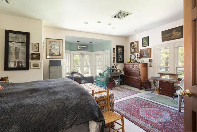 a bed room with furniture and a window
