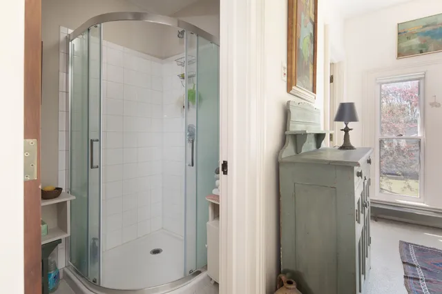 a front view of a house with a yard and trees