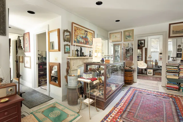 a living room with furniture fireplace and rug
