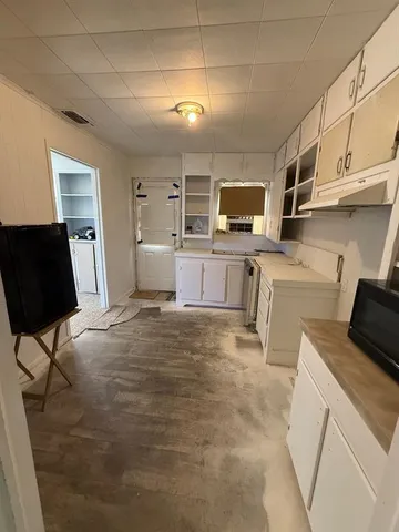 a kitchen with a stove and a refrigerator