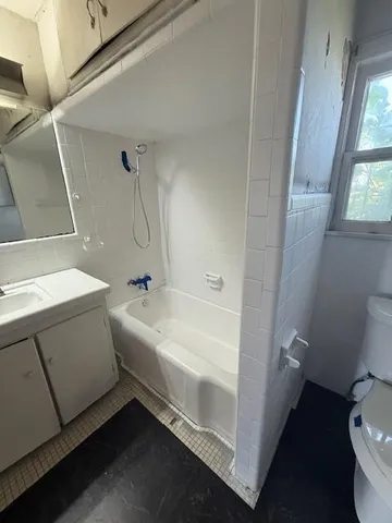a bathroom with a bathtub and a toilet