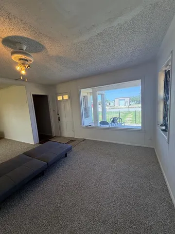 a view of an empty room and a window