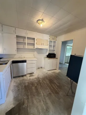 a kitchen with a refrigerator and a stove top oven