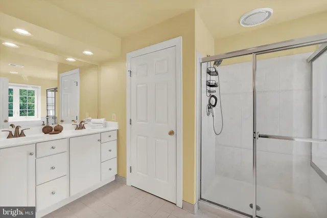 a bathroom with a double vanity sink a mirror a shower and vanity