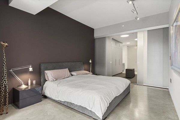 a bedroom with a bed and a lamp