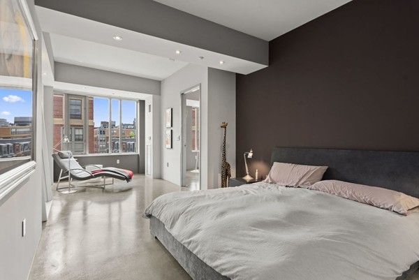 a bedroom with a bed and glass window