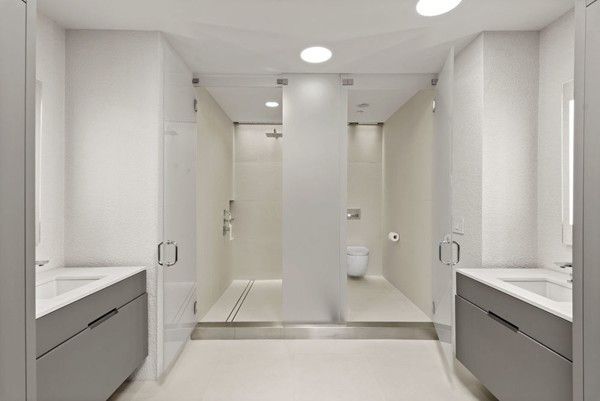 a spacious bathroom with a granite countertop sink mirror and a bathtub